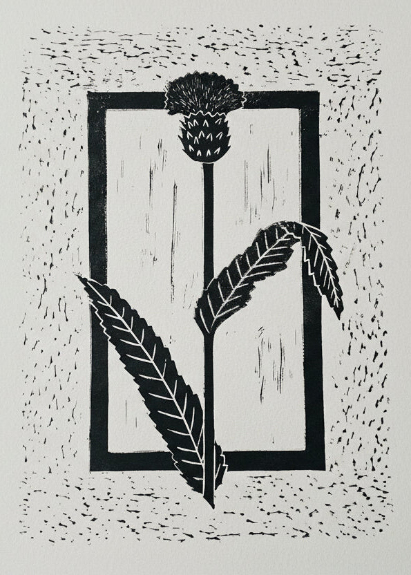 A thistle surrounded by a rectangle linoprint.