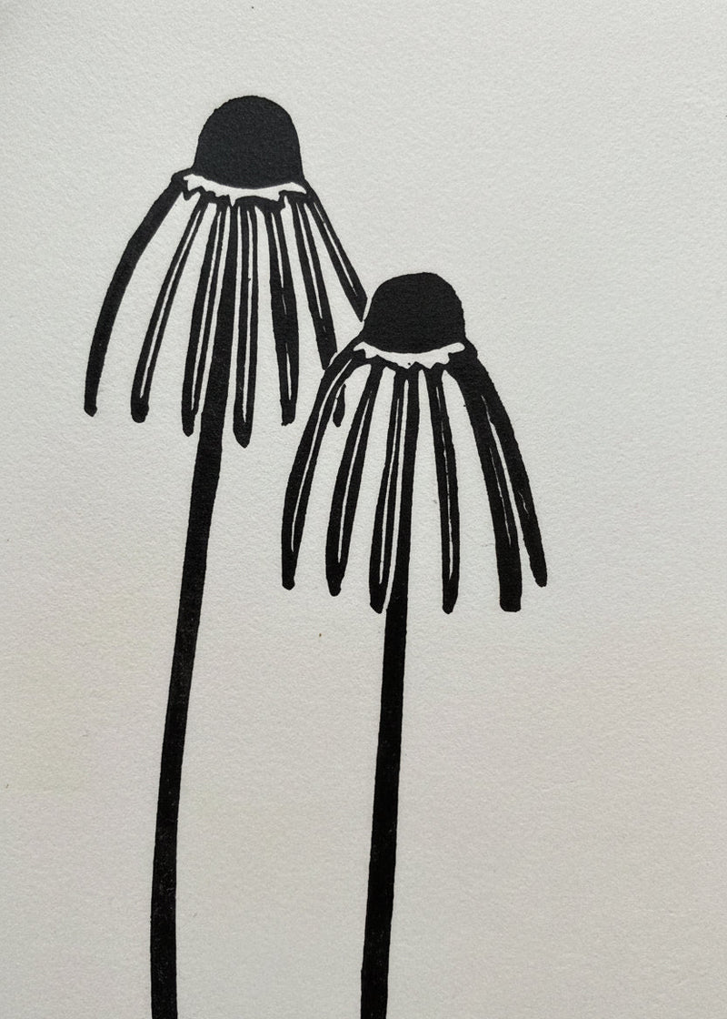 Two black floral illustrations on a white background